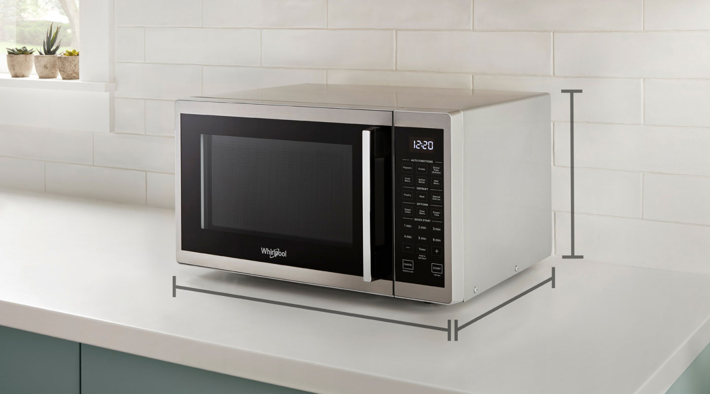 Black and silver countertop microwave with dimension markers infographic