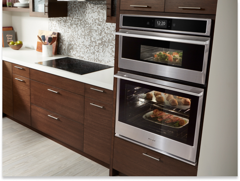 Whirlpool brand combination wall oven and microwave with food inside