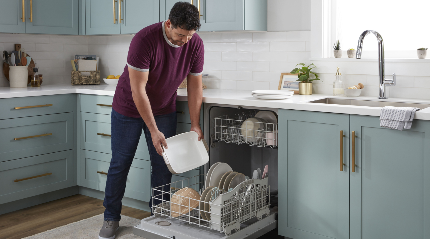 Person loading dishes into a dishwasher