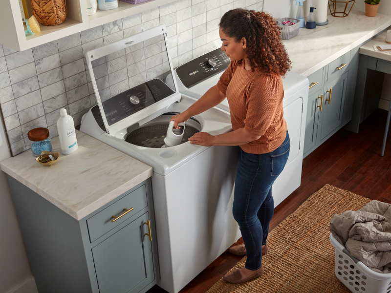 Person removing agitator from washing machine