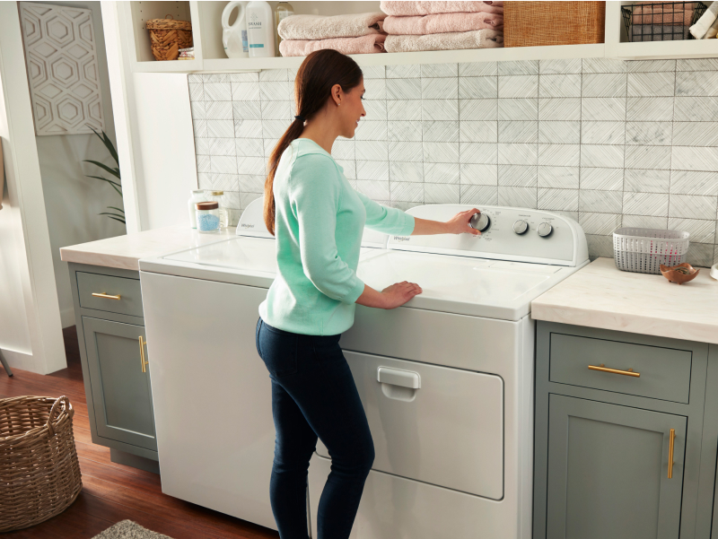 Person turning knob on dryer