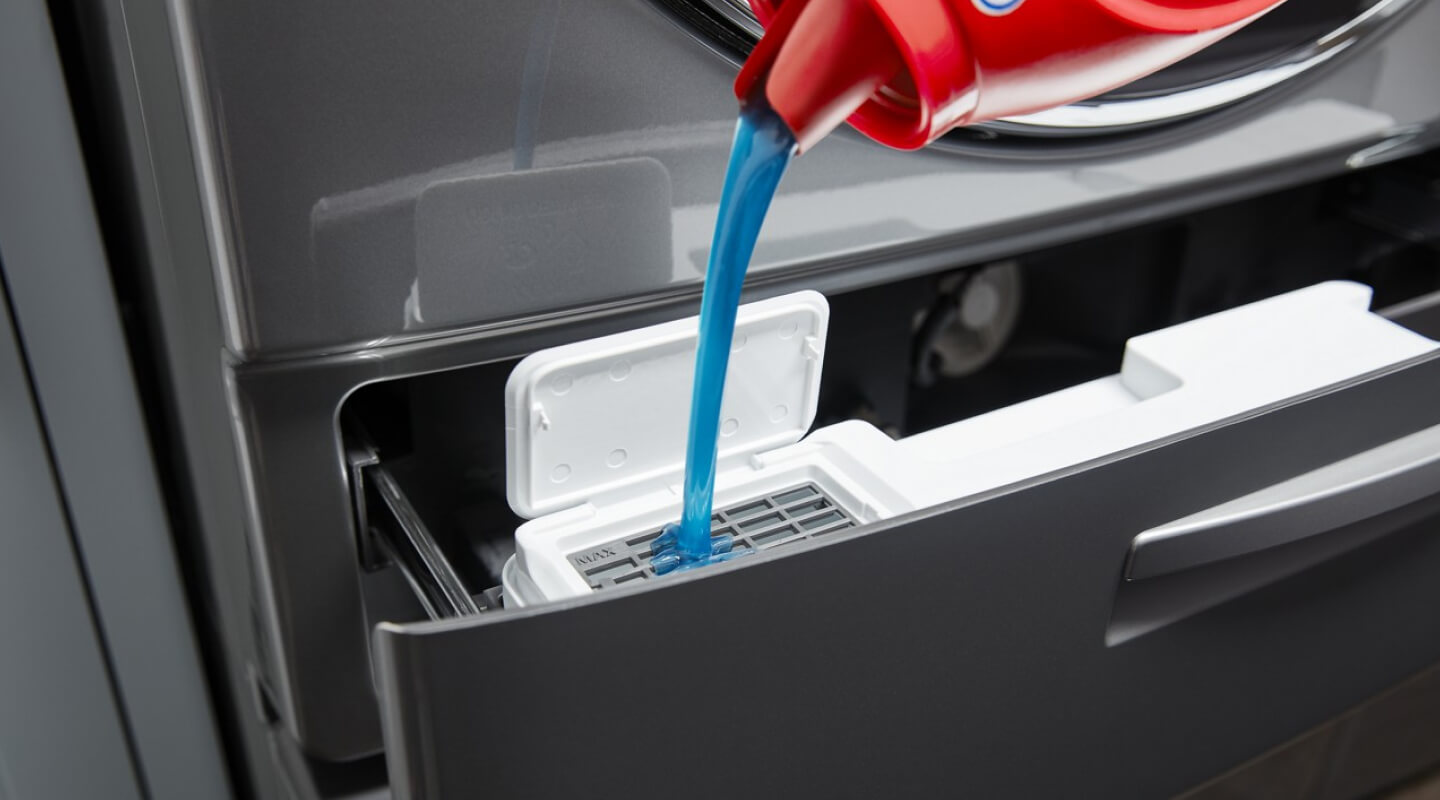 Detergent being poured into a Whirlpool® 5.0 cu. ft. Front Load Washer with Load & Go™ XL Dispenser