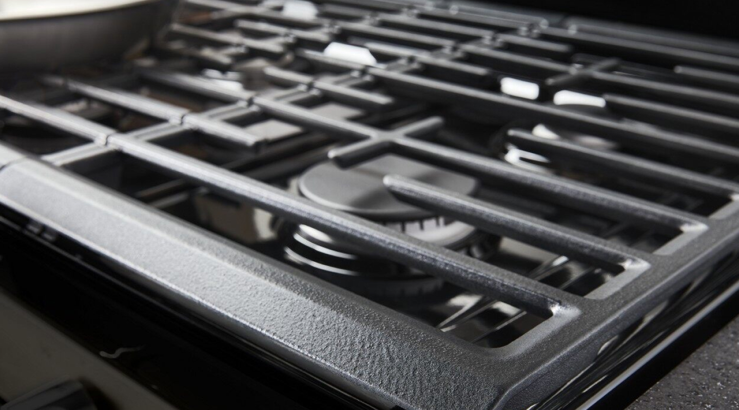 A gas stove burner and grate.