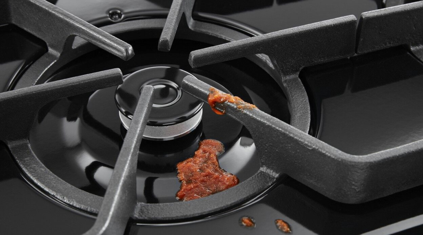 Red sauce on a burner and grate.