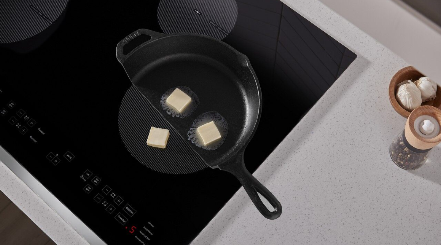 Butter in a cast iron pan melting on a Whirlpool® induction cooktop