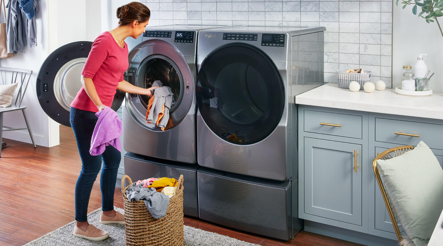 Person putting clothes in the washing machine