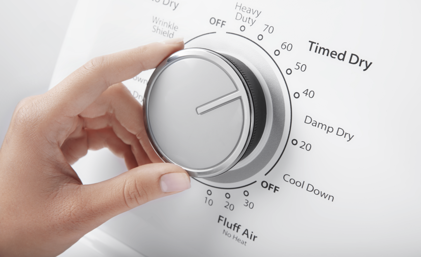 A person selecting dryer settings.