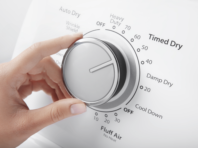 A person selecting dryer settings.