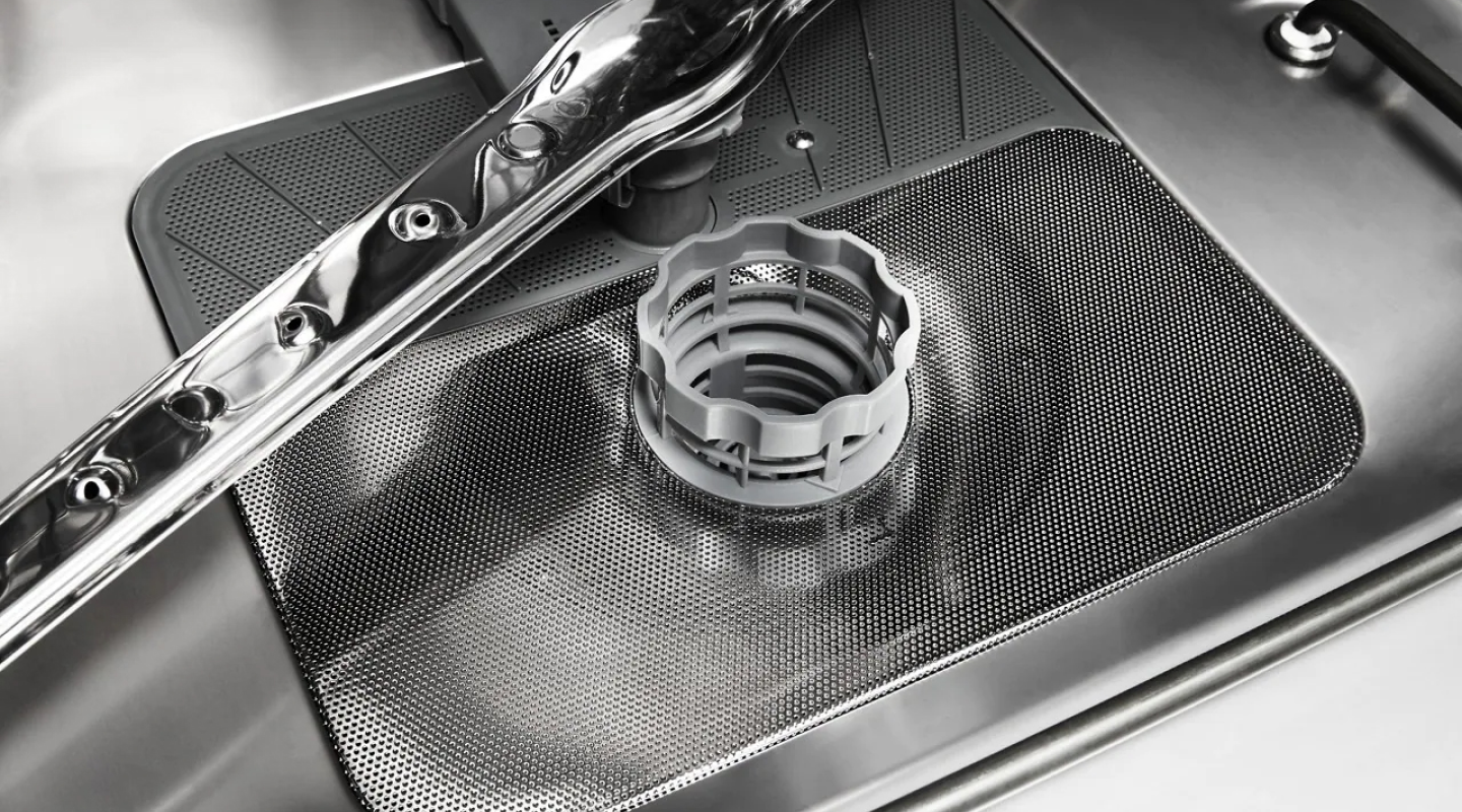 Dishwasher filter in a stainless steel dishwasher tub
