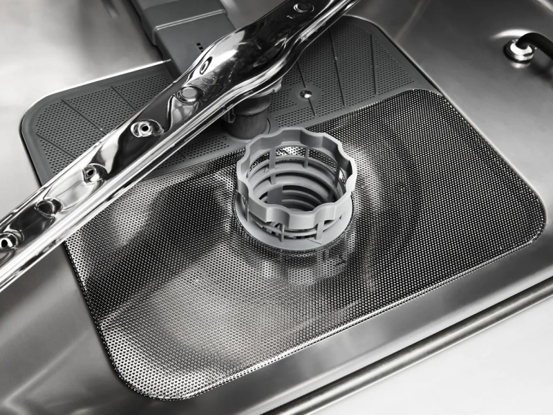 Dishwasher filter in a stainless steel dishwasher tub