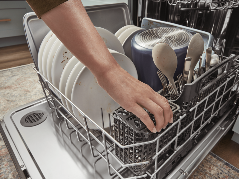Person loading a dishwasher