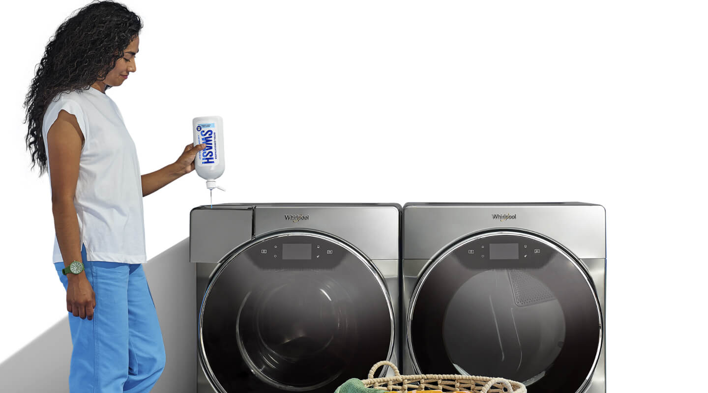 Woman adding Swash® detergent in a front load washing machine