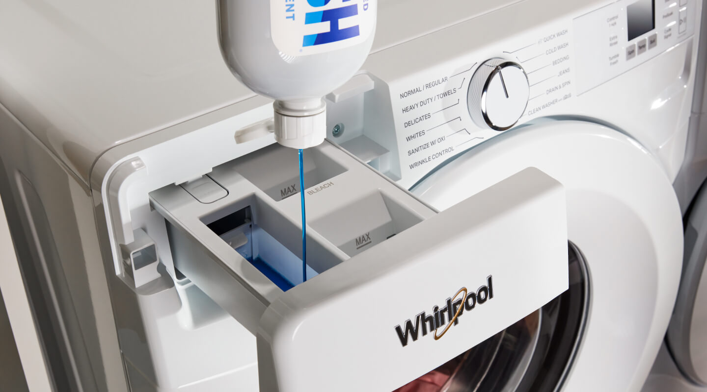 Swash® Laundry Detergent dispensing into a white Whirlpool® Front Load Washer