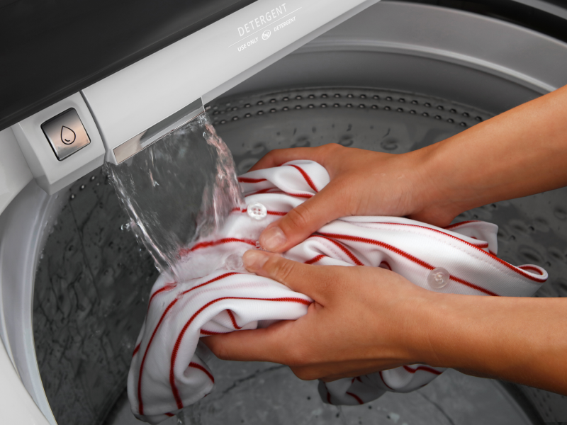  Hands pretreating clothing with built-in water faucet