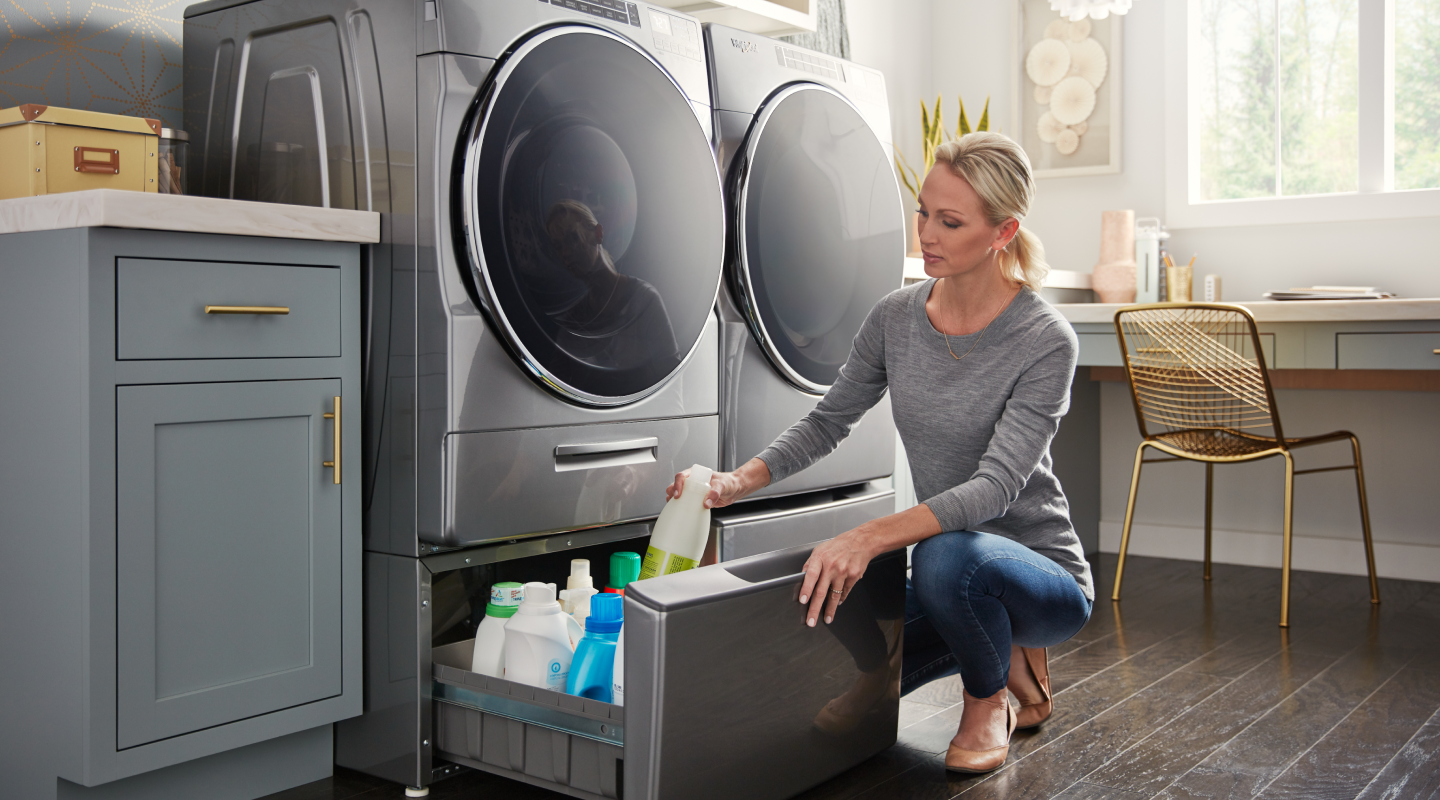 Person at open washer storage drawer