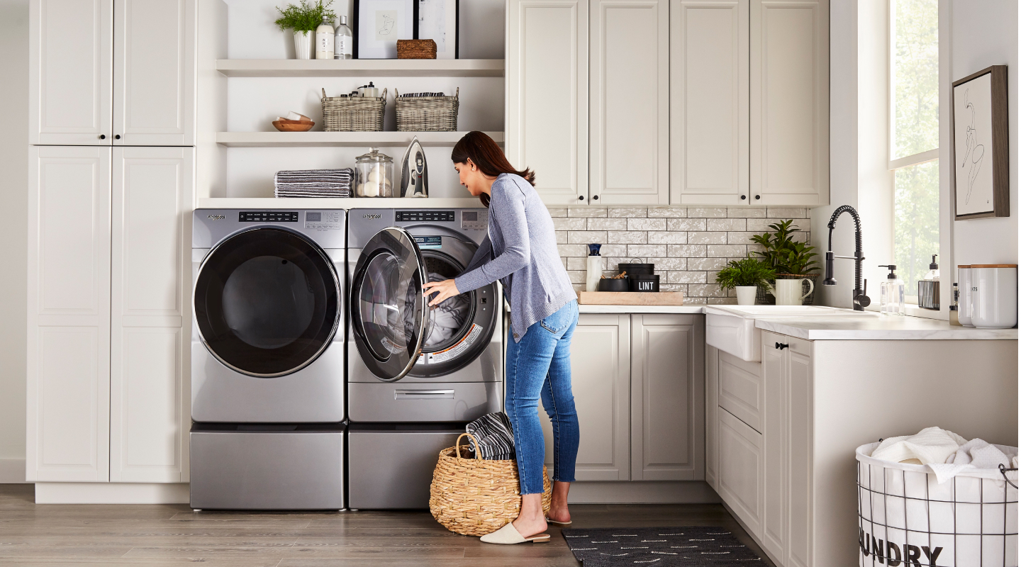 Person loading laundry into Whirlpool® dryer