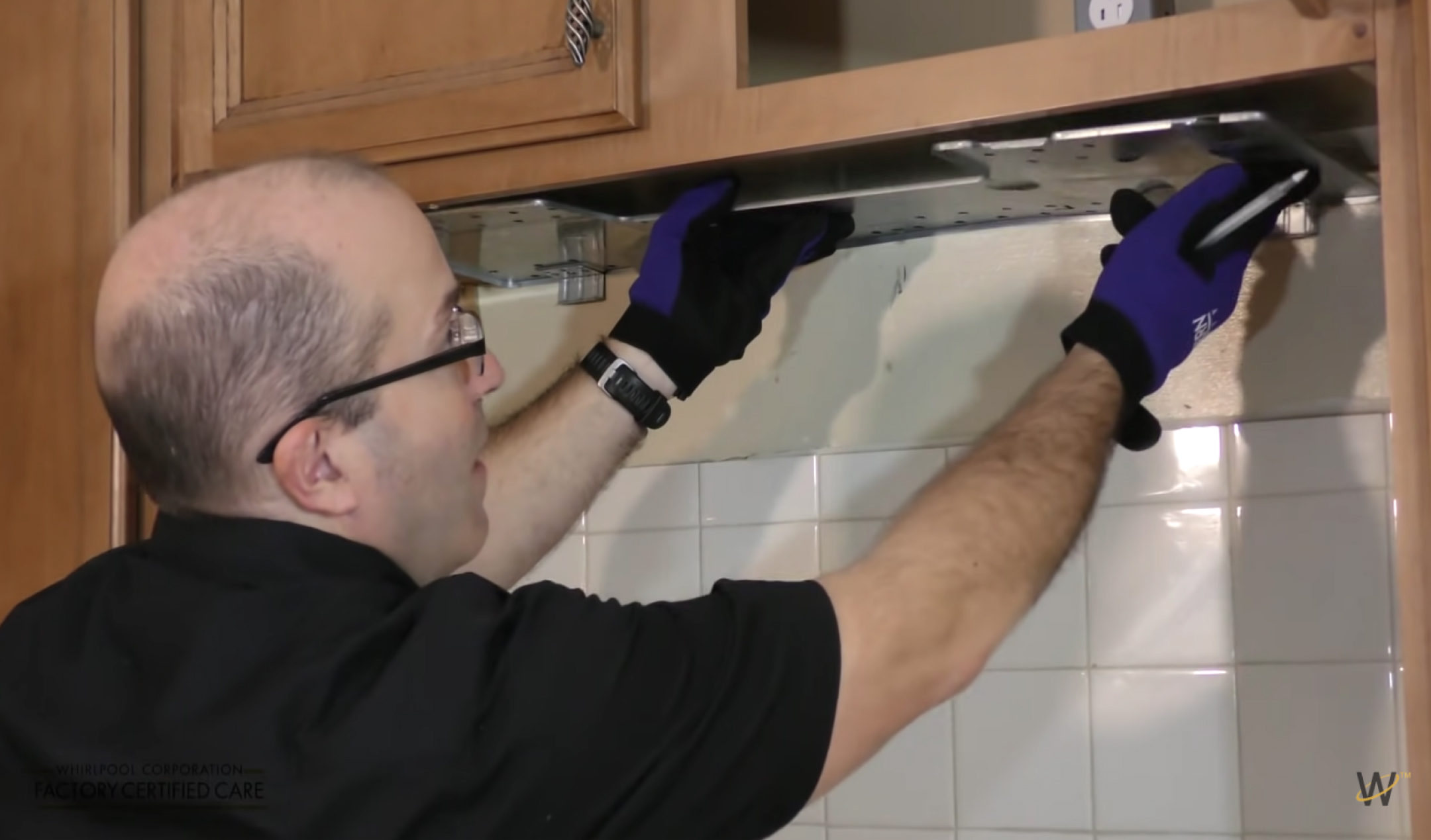 Mounting plate being secured against upper cabinet