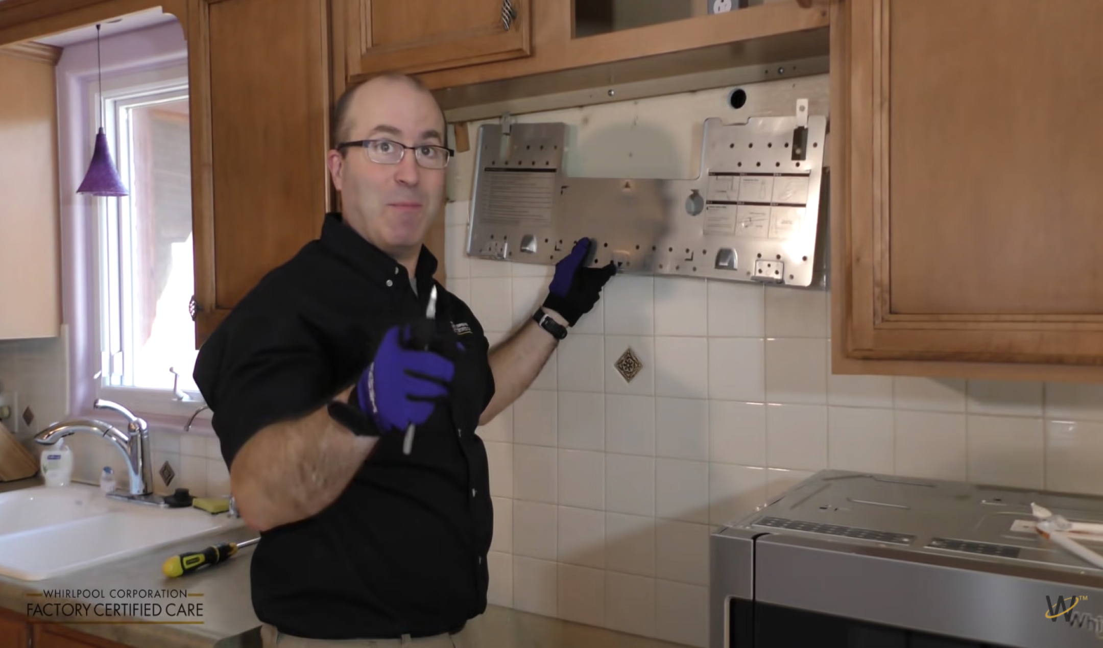 Person holding mounting bracket against wall