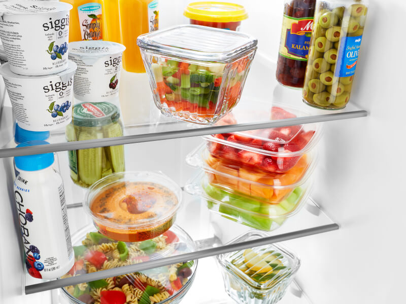 Produce and dairy products inside a refrigerator