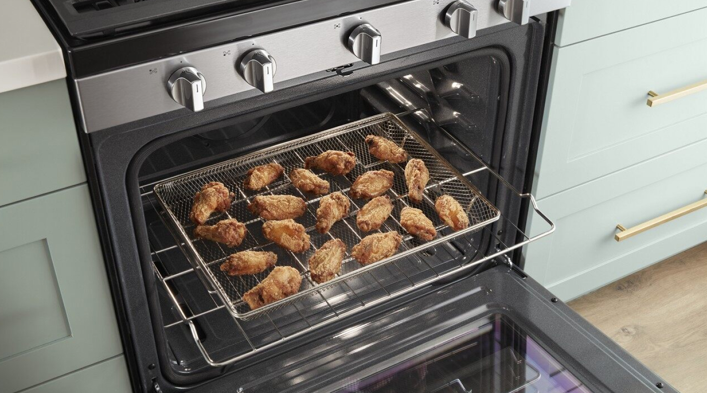 Fried chicken laid out on a cooking rack in the oven