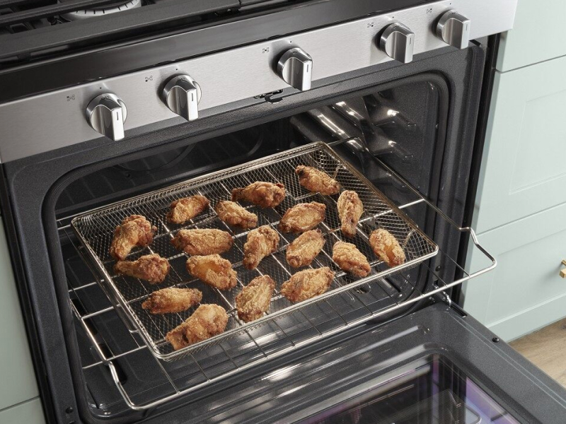 Fried chicken laid out on a cooking rack in the oven