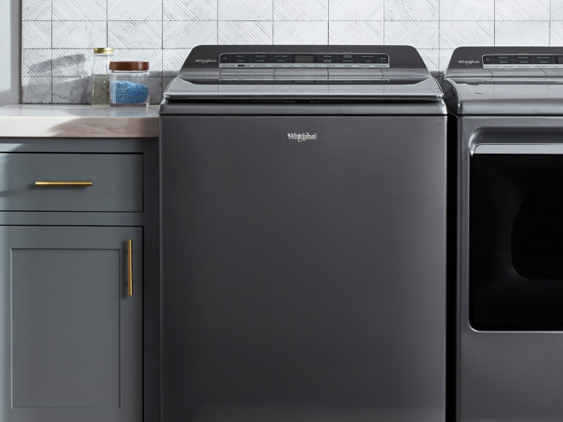 Top load Whirlpool® washer in a laundry room