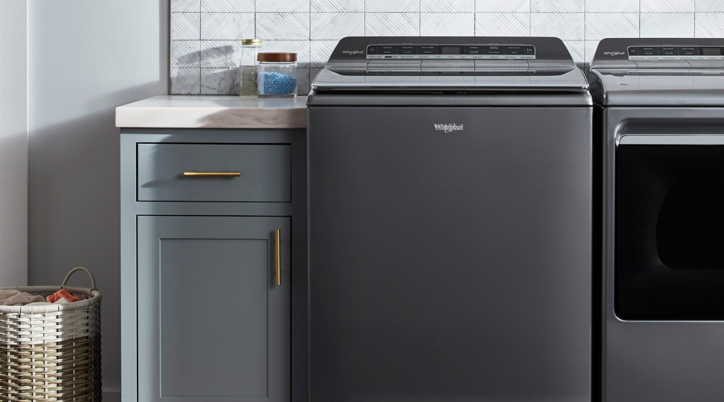 Top load Whirlpool® washer in a laundry room