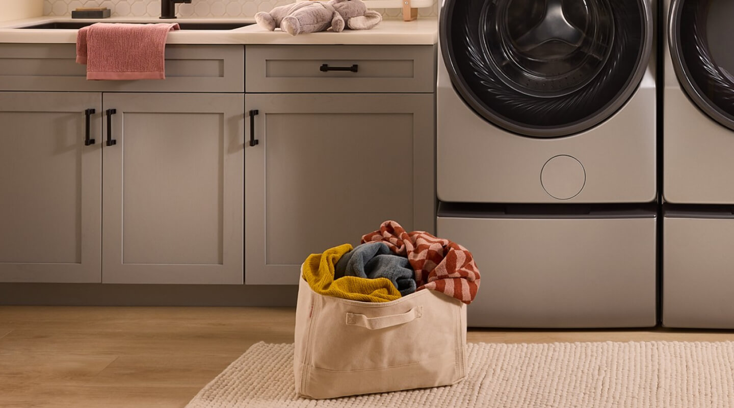 A bag of laundry on the floor of a laundry area