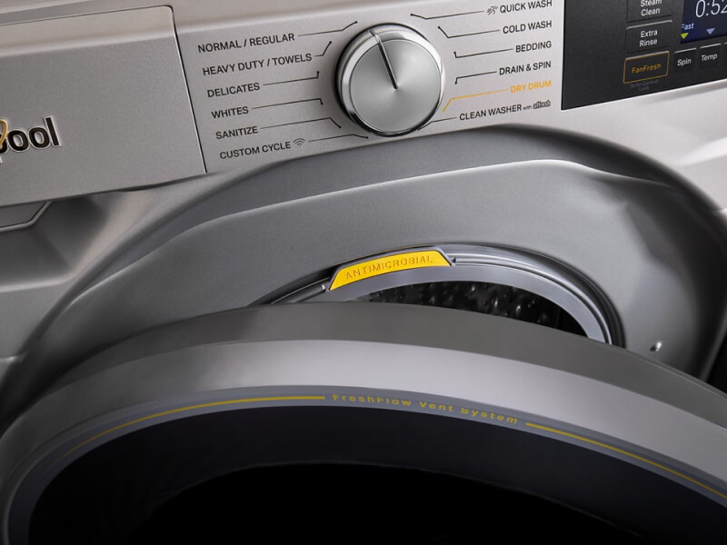 Close up of a front load washer with the door slightly open