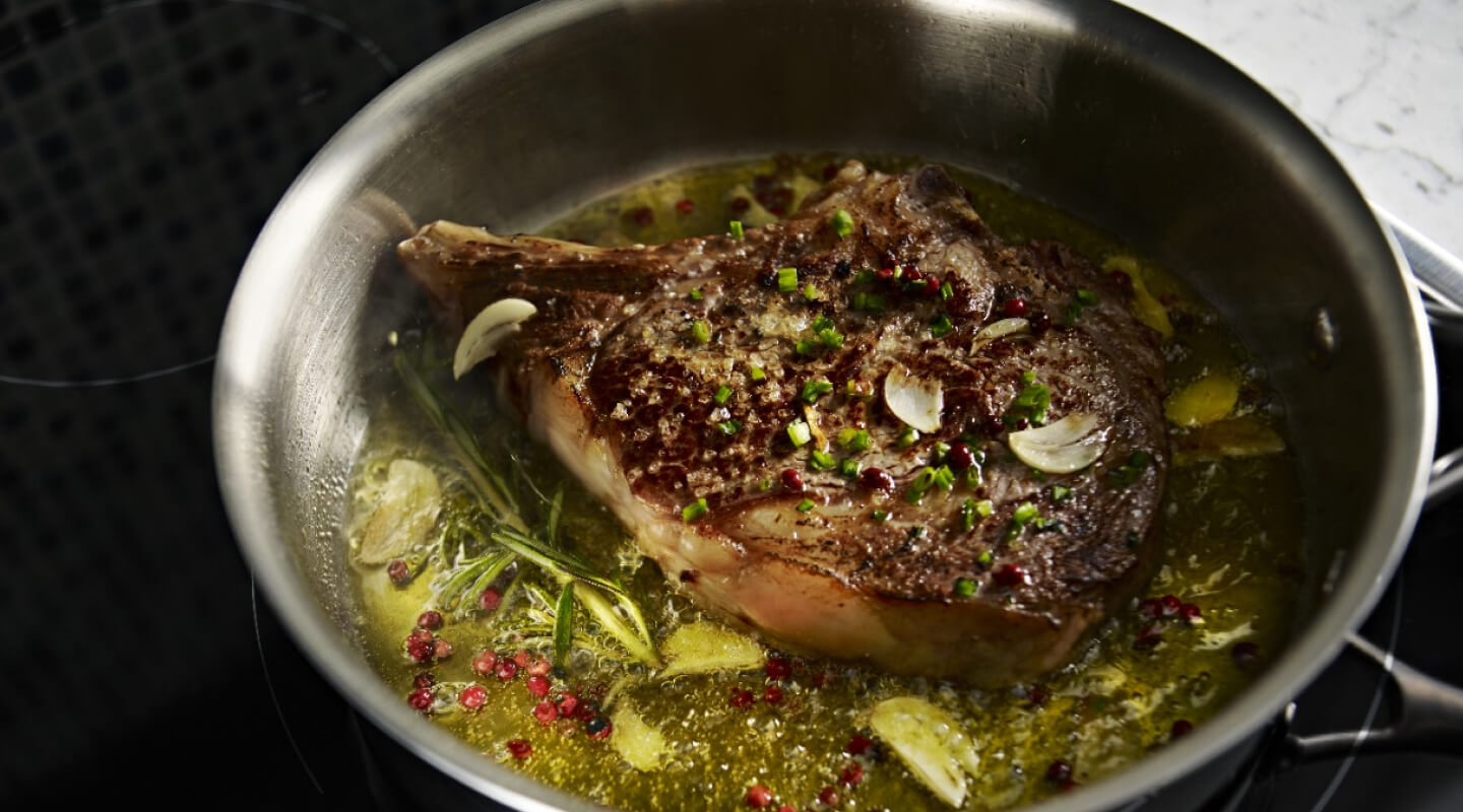 A large piece of meat, simmering in a pot