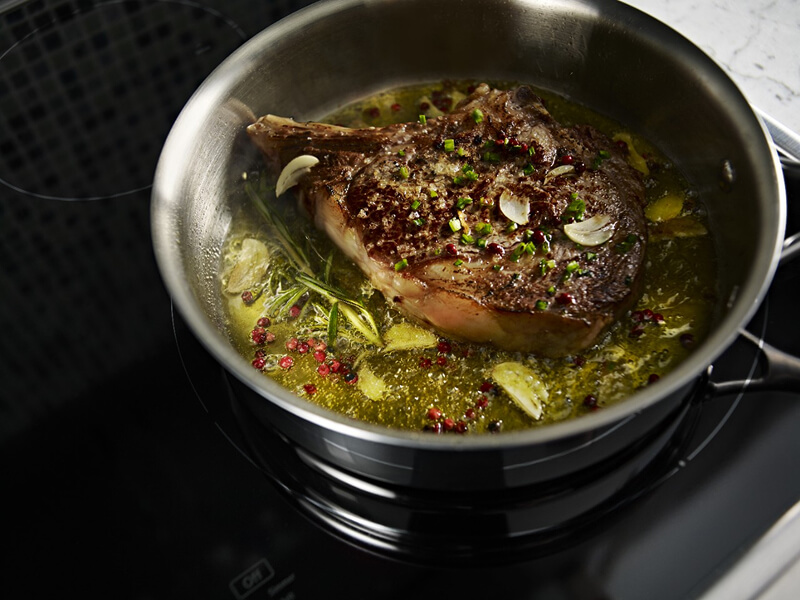 A large piece of meat, simmering in a pot