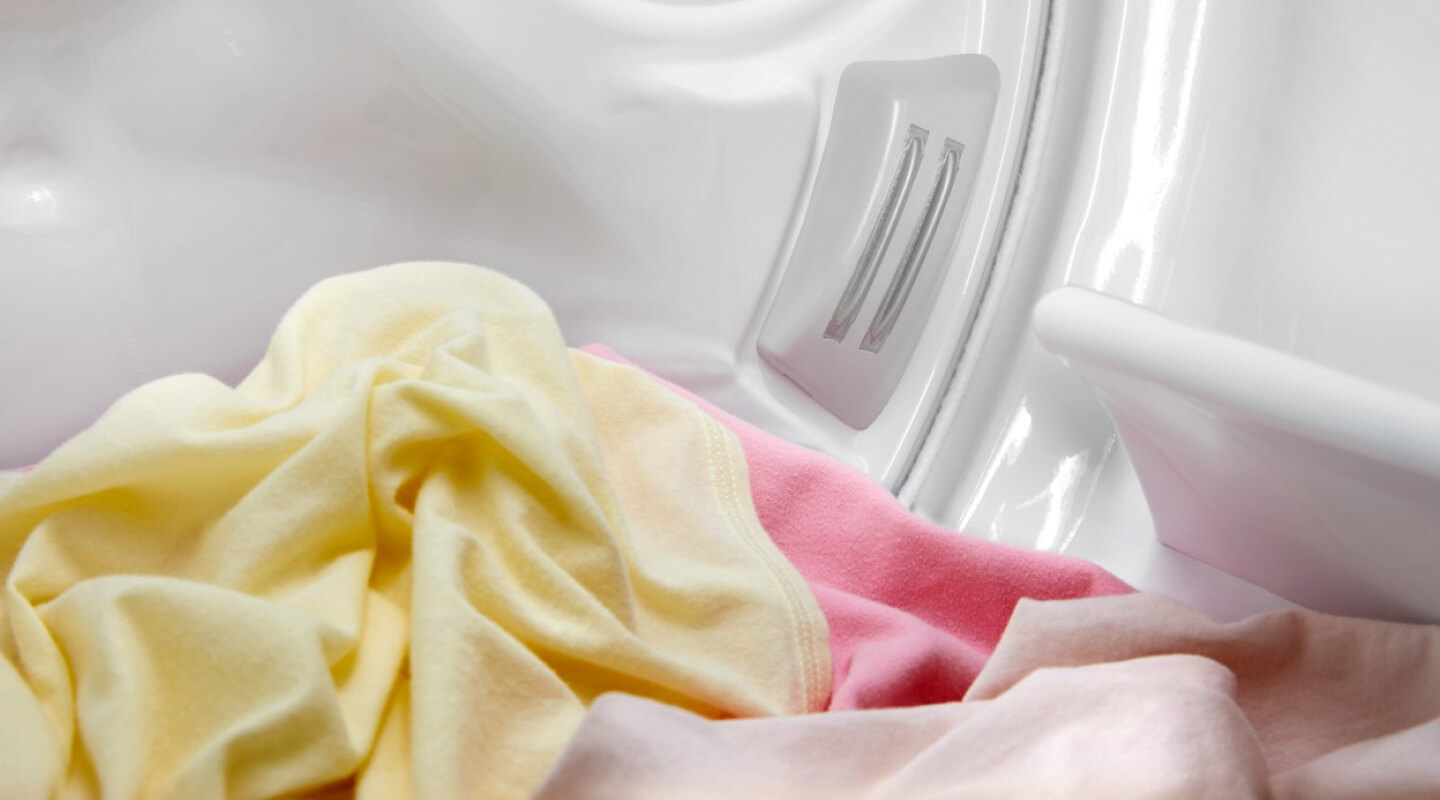 Yellow and pink garments in a dryer