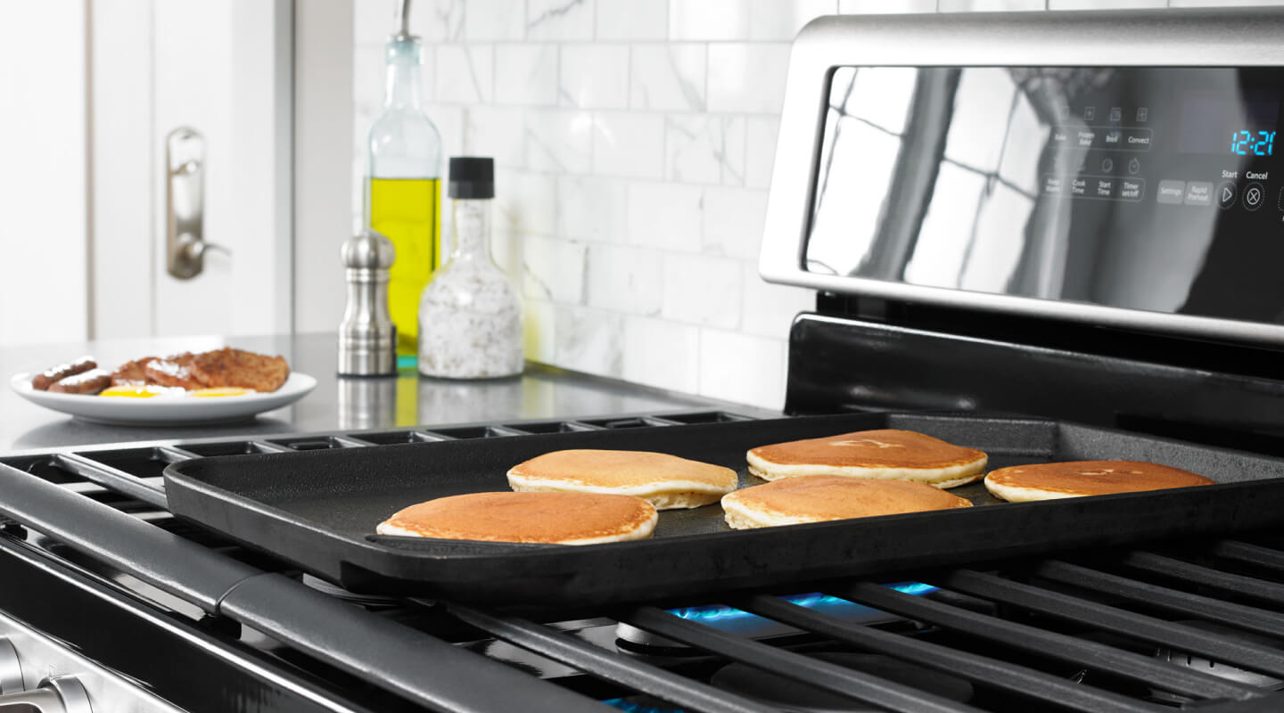 Pancakes cooking on a griddle
