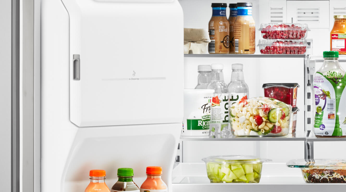 An open fridge door, showing various food products on the shelves