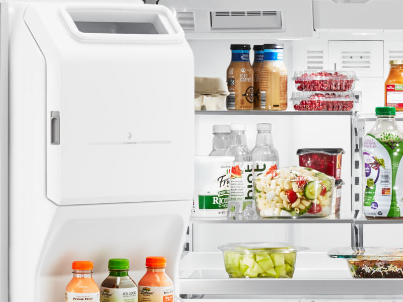 An open fridge door, showing various food products on the shelves