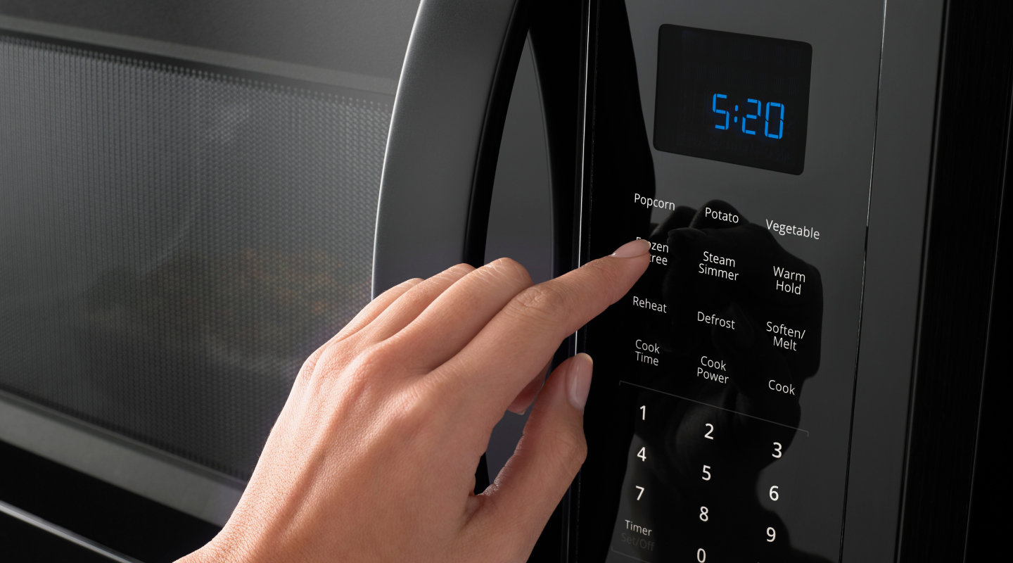 Hand pressing a microwave display