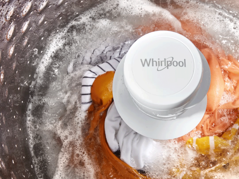 Laundry being washed inside a Whirlpool® top load washing machine