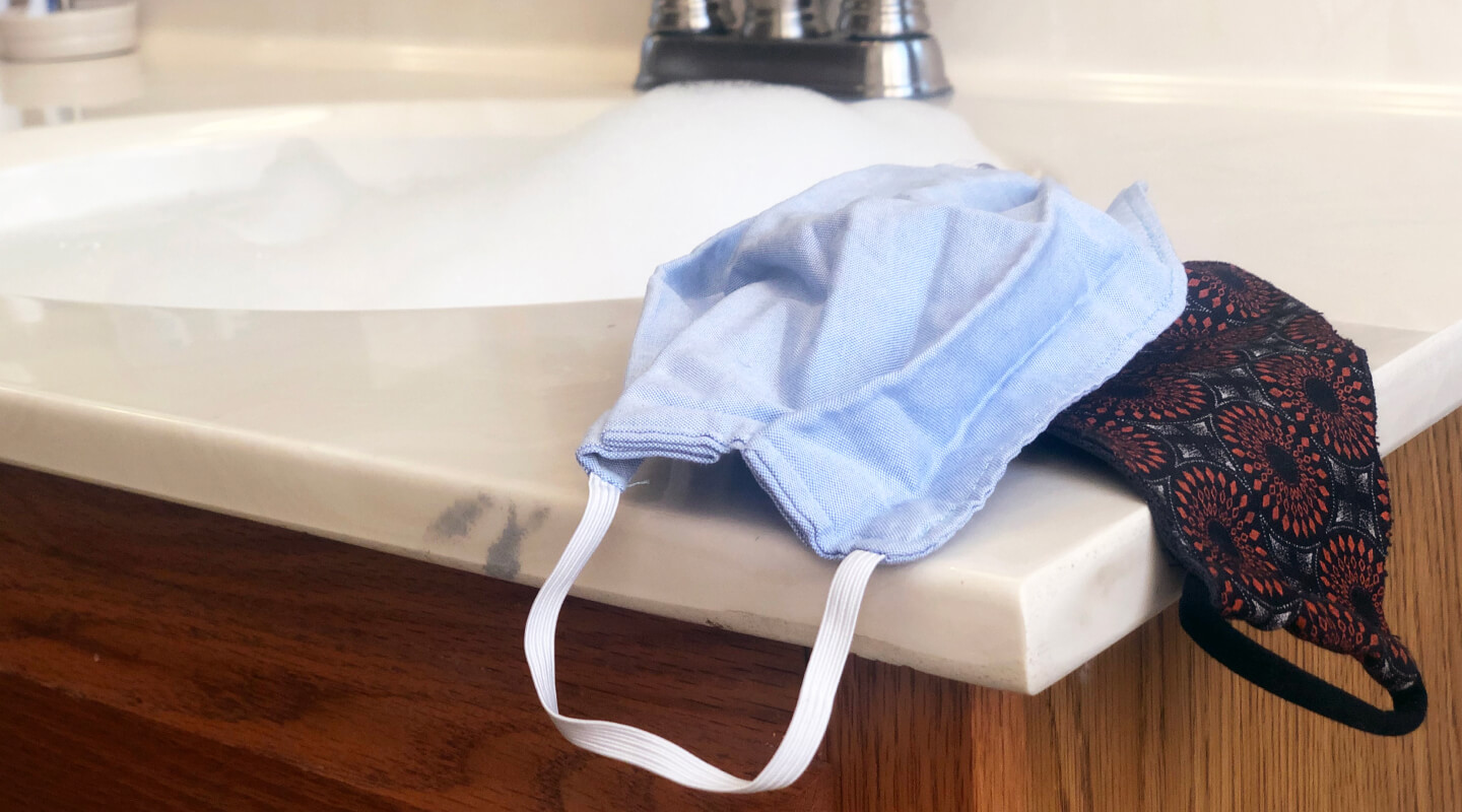 Cloth face masks next to a sink