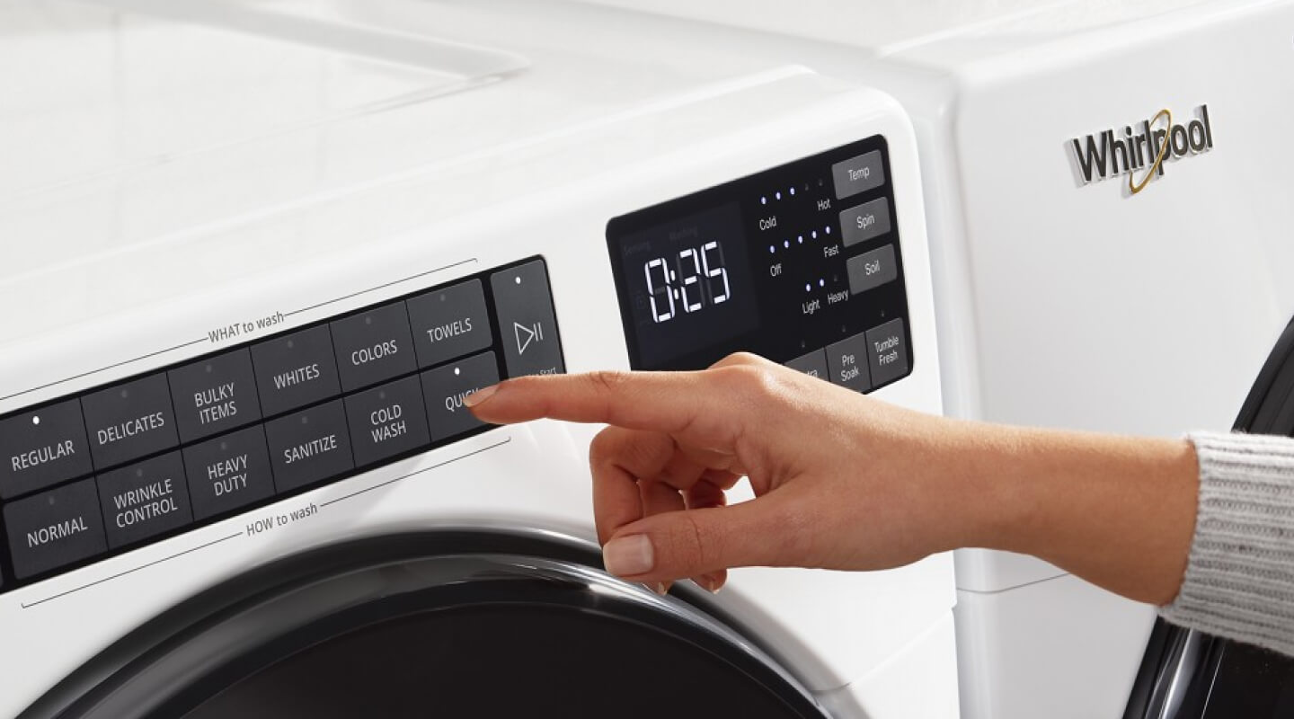 Person selecting settings on a washer control panel
