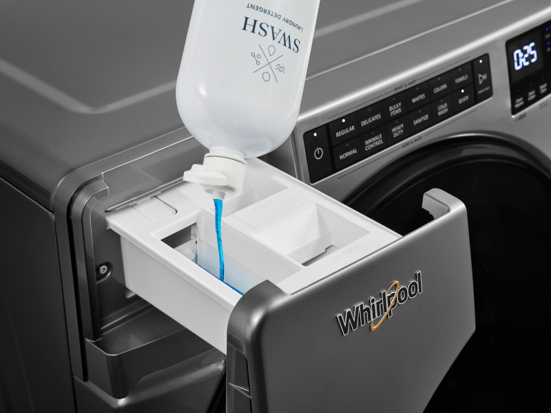 Swash® detergent being poured in a detergent drawer