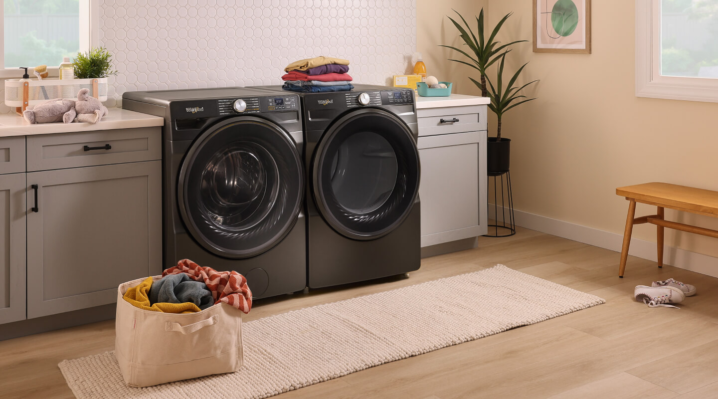 Black front load washer and dryer in a laundry room