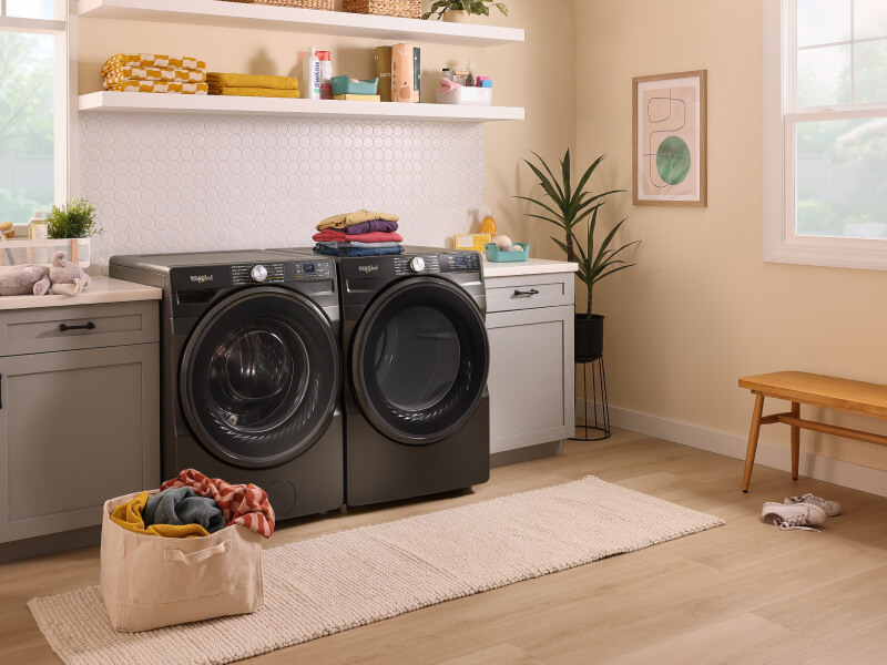 Black front load washer and dryer in a laundry room