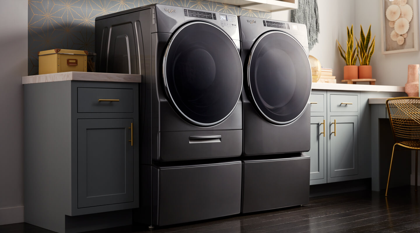 A laundry room with a Whirlpool® Front Load Washer and Dryer Set