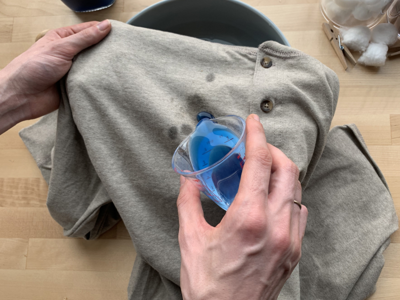 Person spot treating shirt