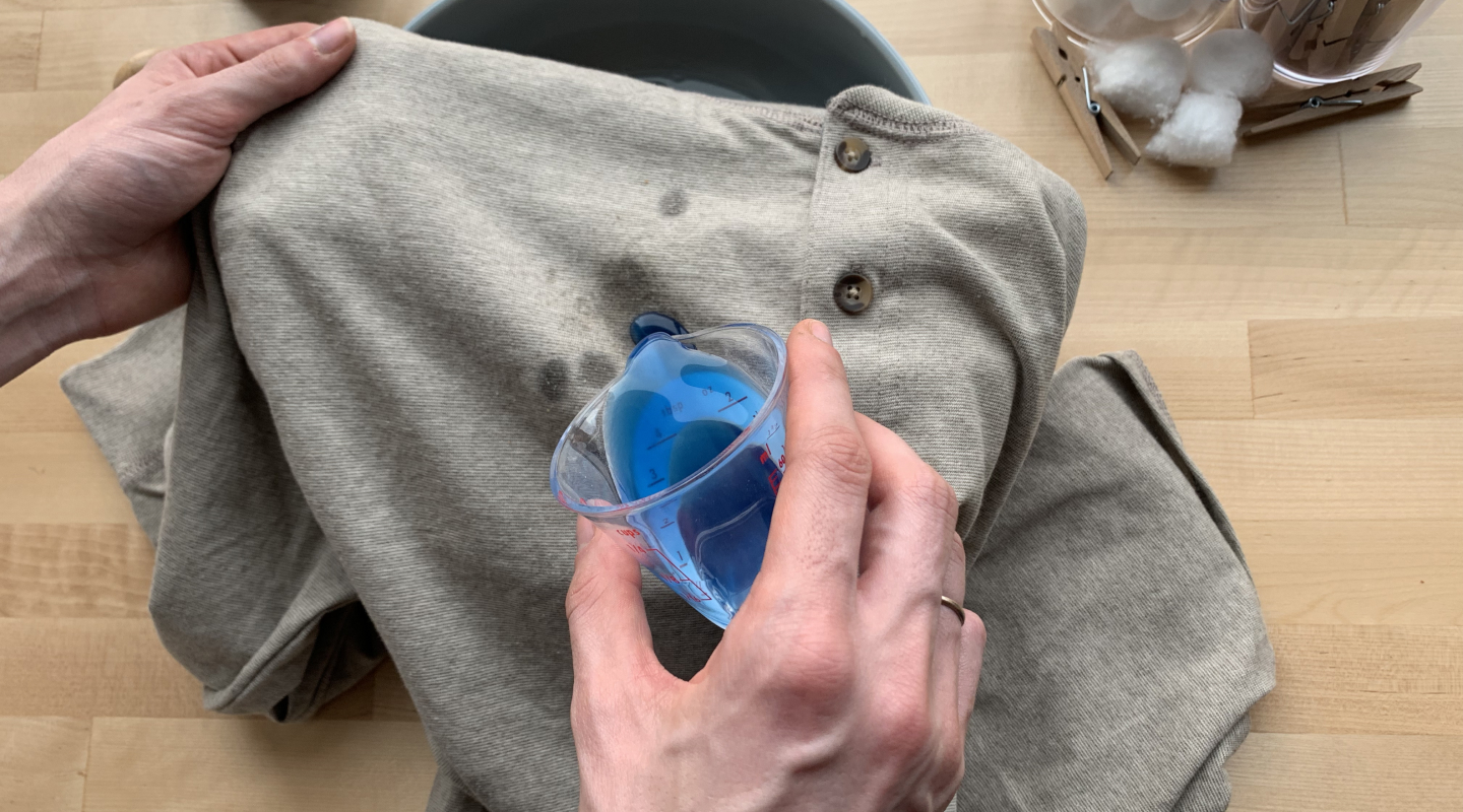 Person spot treating shirt