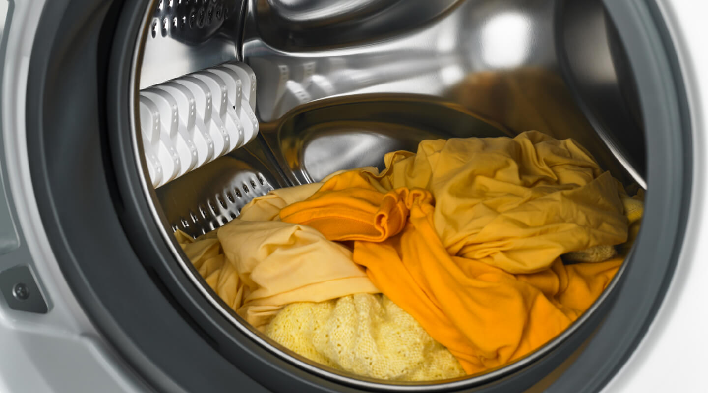 Yellow and orange laundry in a dryer