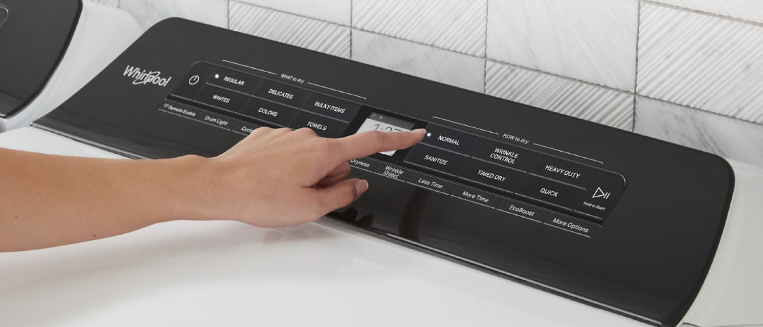 Person selecting a cycle on a Whirlpool® Washer