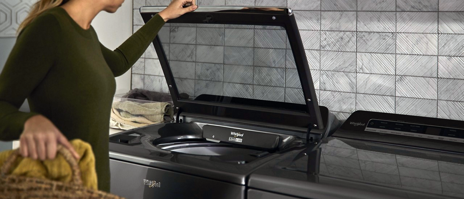 Woman opening a Whirlpool® Washer