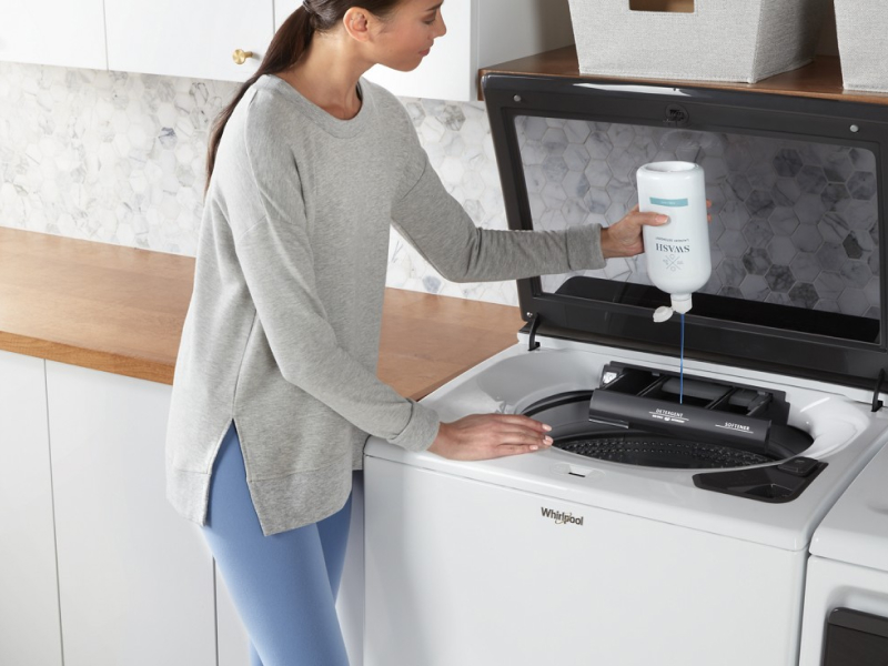 Person adding Swash® to a washing machine