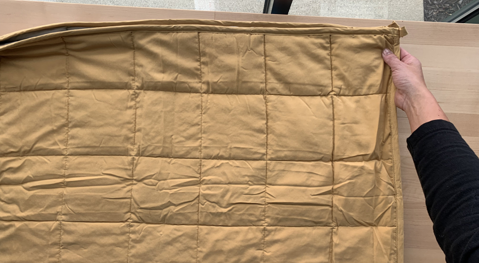 Person folding a weighted blanket 